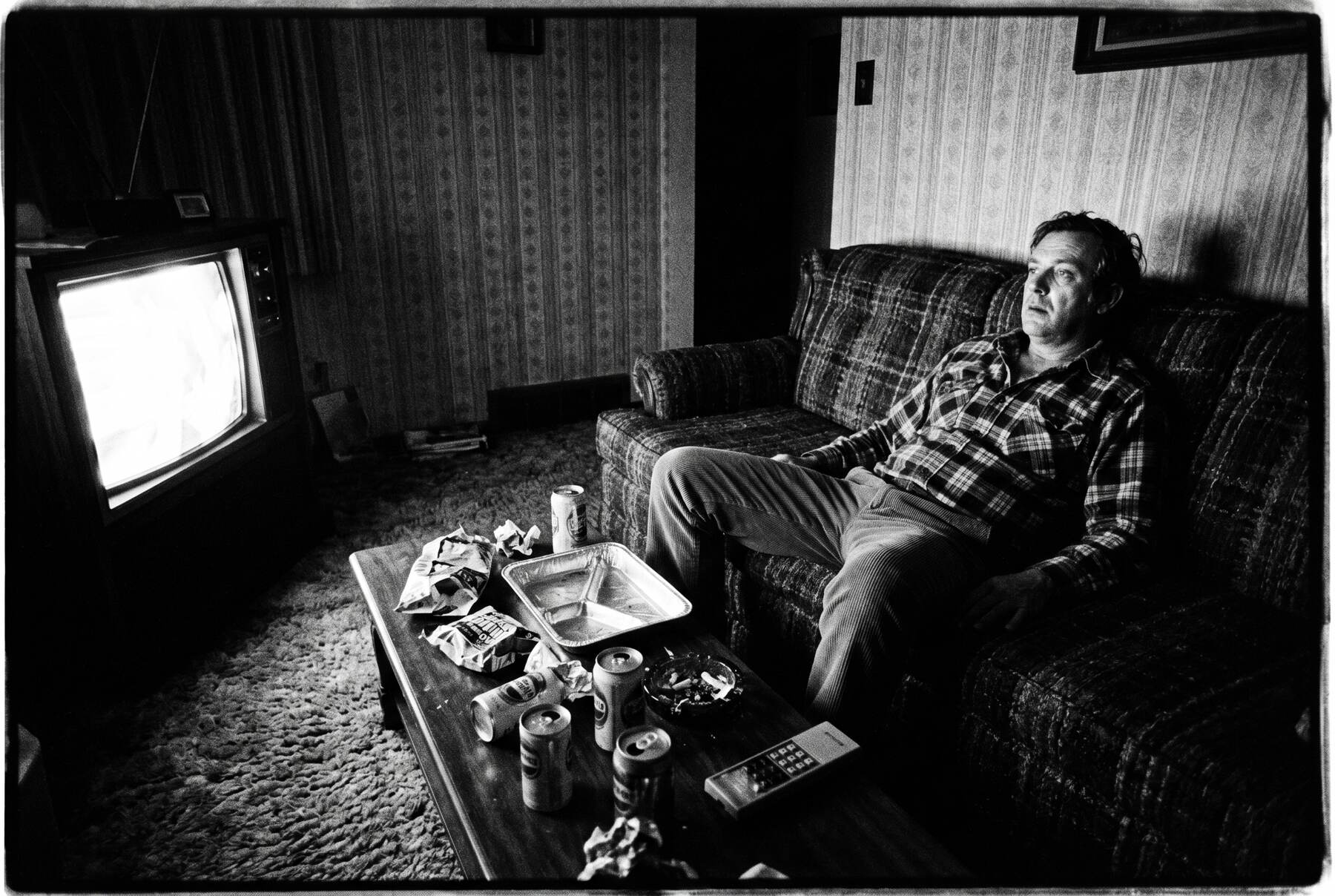 A 1970s-style living room with a couch facing a television, the classic scene of an audience being sold.